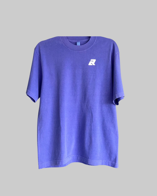 Purple t-shirt with a small white logo on a white background